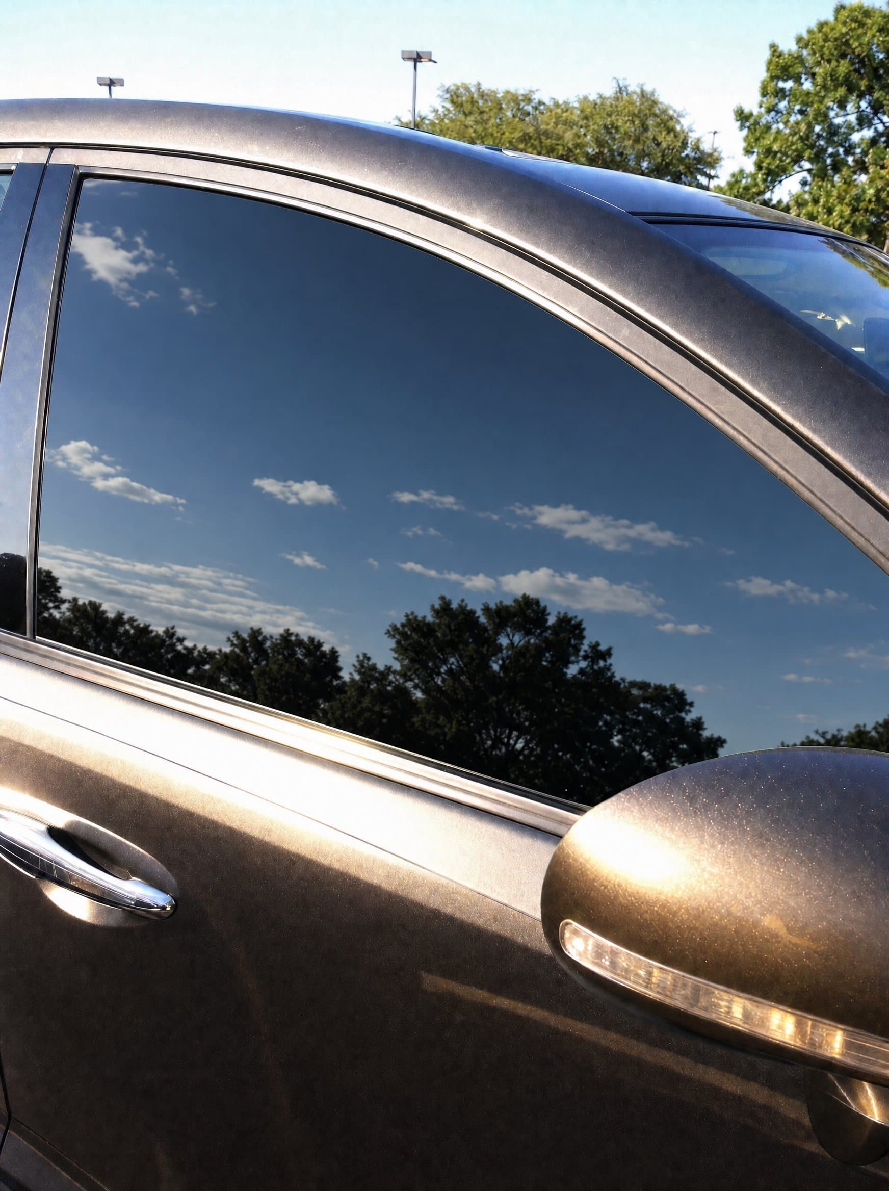 Car window with premium tint installed — cool, dark, glare-free